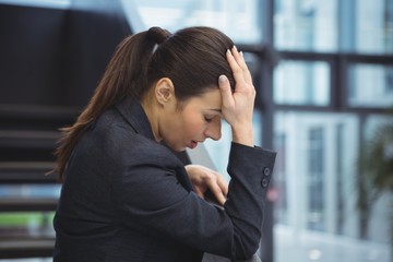 Depressed businesswoman with hand on her head