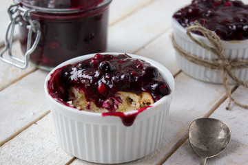 cheesecake in white ramekin , white rose on the side 