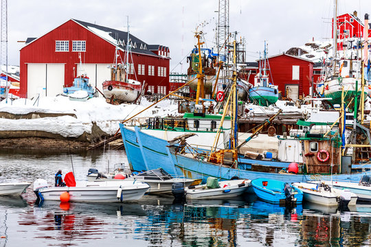 Boats and fishing ships standing on land and water in port of Sisimiut, Greenland