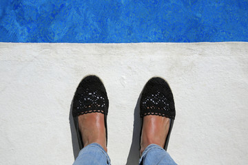 summer vacation selfie suntanned female feet at the edge of the swimming pool