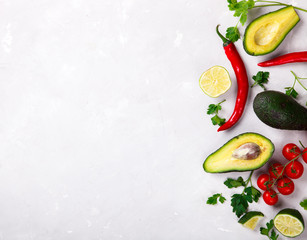 Avocado, lime,Parsley  Chili pepper,Tomatoes on a light Background.Food or Healthy diet concept.Vegetarian.Green food.Copy space for Text. selective focus.