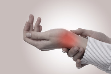 Business woman suffering from wrist pain. Pain relief concept