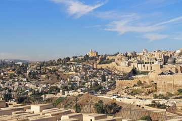 Dormition Abby, St. Peter in Gallicantu and al-Aqsa Mosque in a panoramic view of Jerusalem from a cemetery on the Mount of Olives beside the Kidron Valley.