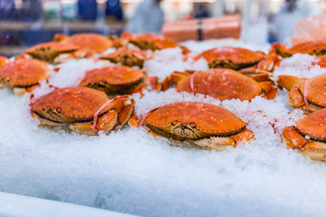 Many whole red cooked crabs on ice © Kristina Blokhin