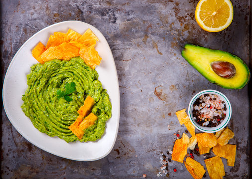Avocado, Vegetable.Guacamole is a Traditional Mexican Sauce with Nachos.Food or Healthy diet concept.Copy space for Text. selective focus.