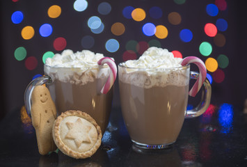 Hot chocolate with cream, candy canes, mine pies and gingerbread men © stephm2506