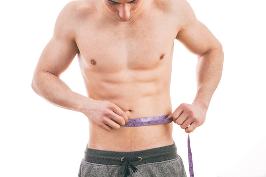 Male torso and blue tape measure on white background