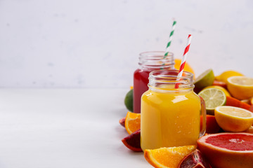 Juices Fresh Orange and Citrus on a White Background.Healthy Beverage.Food or Healthy diet concept.Mixed Colorful Tropical Background.Copy space for Text. selective focus