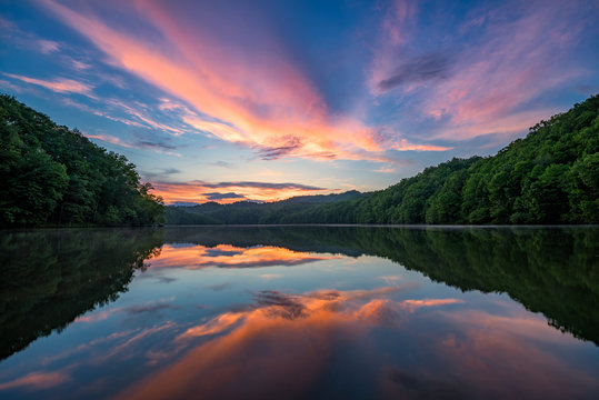 Scenic summer sunset over calm lake, Appalachian mountains