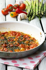 Roasted tomatoes with herbs and garlic. Rustic style.
