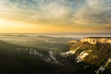 Obraz na płótnie Canvas Valley in the mountains under sunset sky