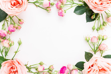 Floral frame with pink roses isolated on white background. Flat lay, top view. Floral background. 