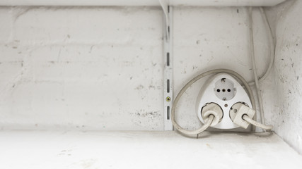 Multi Plug mounted on a wall, white, extension, 2 pin, spread, outlet, workshop, old