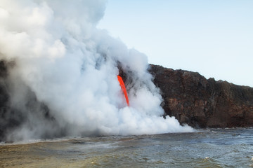 Fototapeta na wymiar Lava pours into the ocean in Hawaii 2017