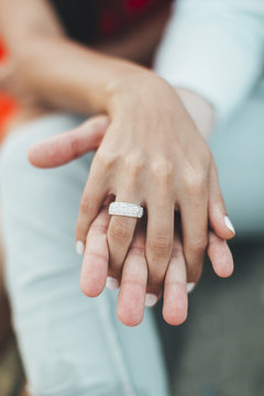 Close-up of a Man and woman holding hands with interlocking fingers