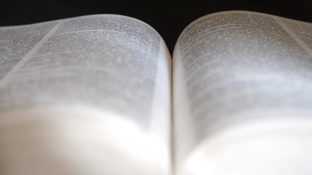 Detailed view of an open book. Refocus the camera shot.