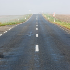 Empty long highway with fog
