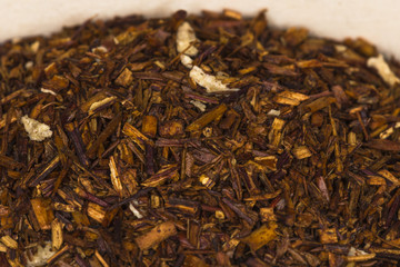 Red karkade floral tea on wooden board