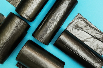New black garbage bags on a blue background.