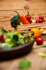 Sweet pepper, brocoli and cherry tomato. Mix salad leaves. Natural raw vegetables. Organic bio food on rustic wooden table.