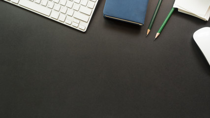 workspace desk with keyboard and notebook copy space background  black