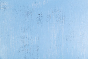 Blue wood background. Painted scraped wooden board. Grunge plywood texture or pattern.