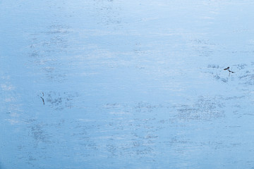 Blue wood background. Painted scraped wooden board. Grunge plywood texture or pattern.