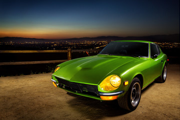 Vintage green sports car at sunset