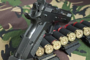 Firearm Pistol on military camouflage background - 140729545