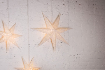 Fototapeta na wymiar big stars decor on the white wall. Shiny stars. weeding decoration with big size stars. Party decor
