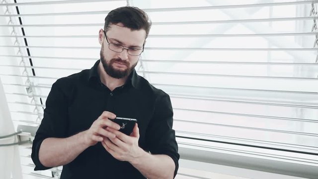 Young businessman with smartphone