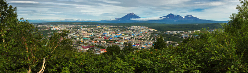 Summer panorama of Petropavlovsk-Kamchatsky on background Avachinskaya group Volcano. View from Mishennaya hills.