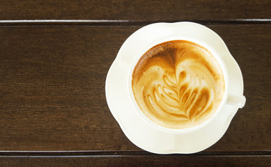 Cup of latte coffee on table