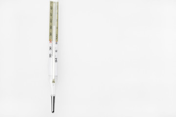 Close up of glass tube and mercury thermometers on white background take with selective color technique and art lighting