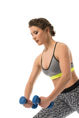 Fototapeta premium Pretty slim brunette posing with dumbell in studio