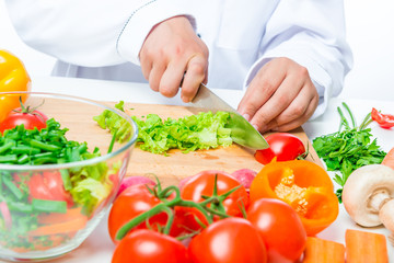 chopped lettuce and cook hand with a knife close up
