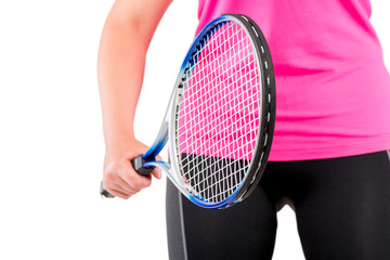 racket in the hands of the athlete close-up at the level of hips