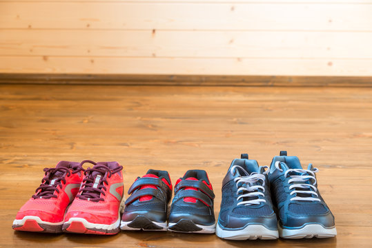Sneakers for the whole family for sports on the wooden floor
