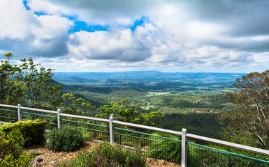 Fototapeta na wymiar The panoramic view in sunny day with big culumus clouds on montains from Picnic Point Lookout in Toowoomba, Australia