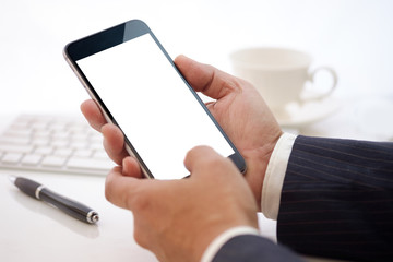 Businessman Showing Blank screen smartphone at work table.