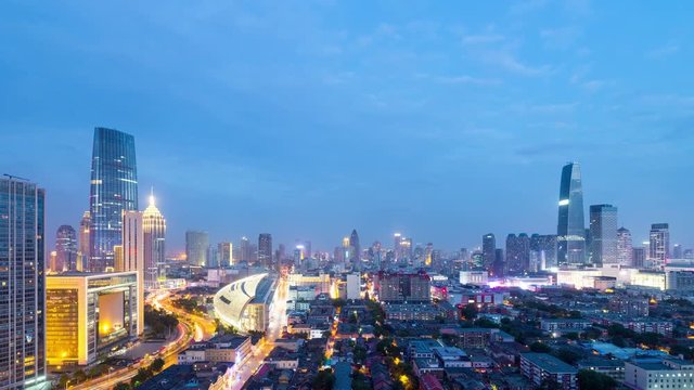 time lapse of tianjin in nightfall , aerial view of beautiful modern city ablaze with lights 
