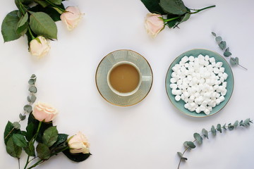 Coffee with marshmallows and a rose on a white  background.Top view. Holiday concept