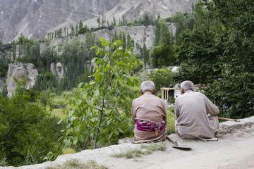Two old man sitting on the road. Karimabad Hunza valley, Pakistan