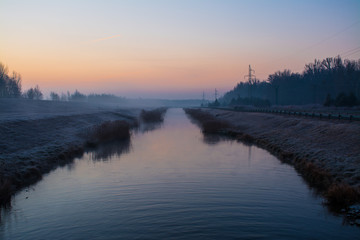 Fototapeta na wymiar Controlled water flow of the Danube River at sunrise