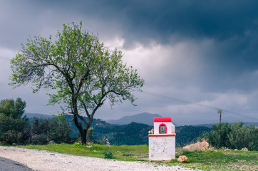 small church next to an almond tree waiting for the storm