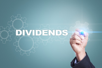 Businessman drawing on virtual screen. dividends concept.