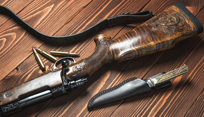 Hunting equipment with knife on old wooden background