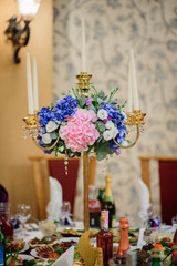Pink and blue hydrangeas decorated golden candleholder