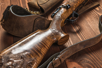 Hunting equipment on old wooden background