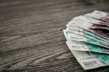 Russian ruble banknotes, money on dark wood background